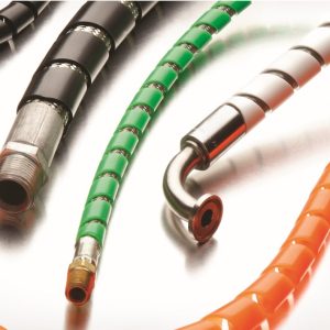 Close-up of flexible hoses with metal fittings in black, green, and orange on a white surface.
